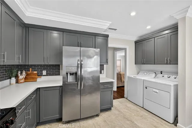 a kitchen with a refrigerator sink and cabinets