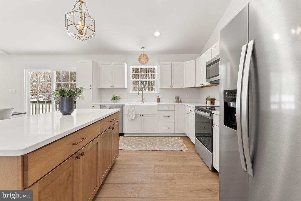 18289 Cameron Road Gordonsville, VA 22942 - Photo 18 of 71 a kitchen with white cabinets and stainless steel appliances