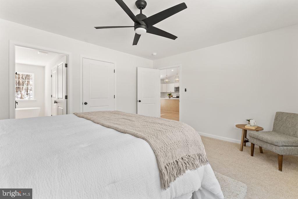 18289 Cameron Road Gordonsville, VA 22942 - Photo 25 of 71 a spacious bedroom with a bed and a chandelier
