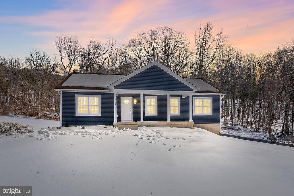 18289 Cameron Road Gordonsville, VA 22942 - Photo 3 of 71 a front view of a house with a yard covered in snow
