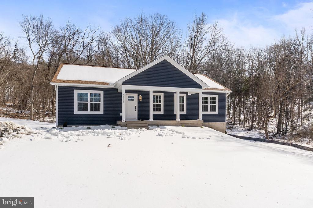 18289 Cameron Road Gordonsville, VA 22942 - Photo 60 of 71 a front view of a house with a yard covered in snow