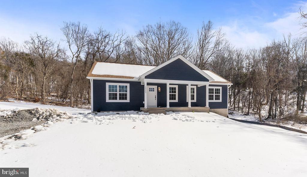 18289 Cameron Road Gordonsville, VA 22942 - Photo 61 of 71 a front view of a house with a yard covered in snow