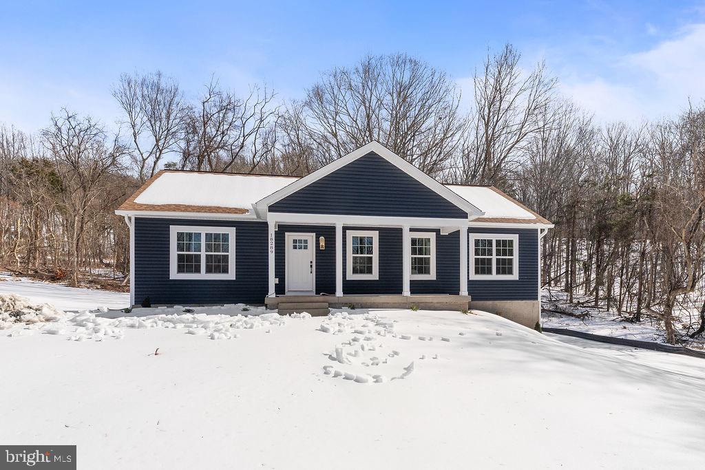 18289 Cameron Road Gordonsville, VA 22942 - Photo 62 of 71 a front view of a house with a yard covered in snow