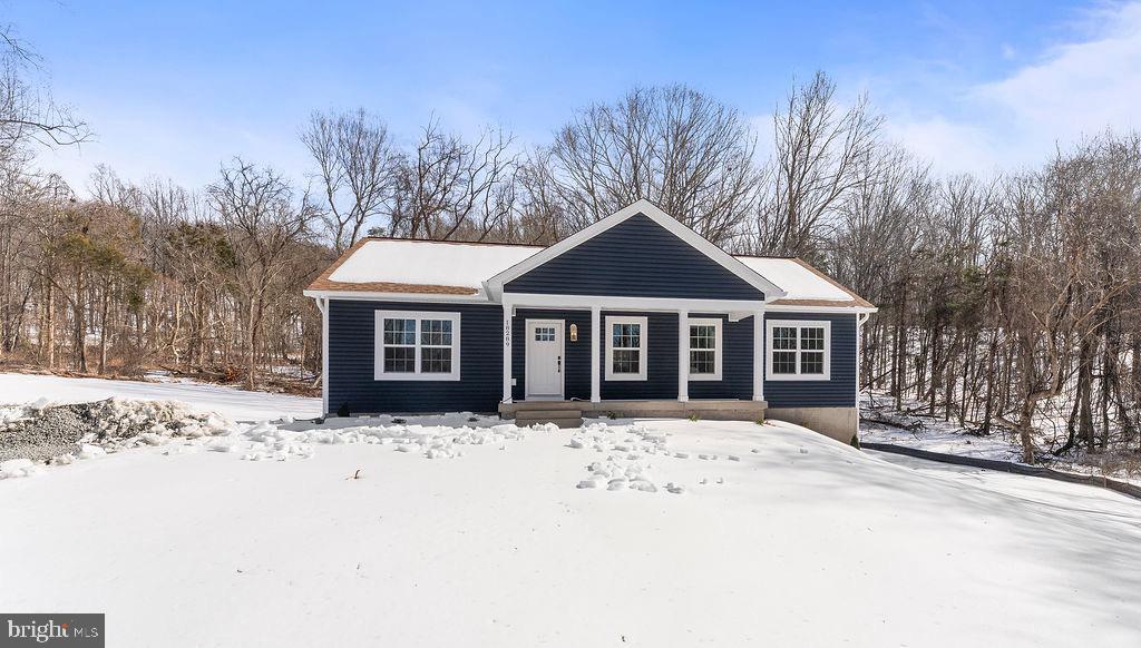 18289 Cameron Road Gordonsville, VA 22942 - Photo 63 of 71 a front view of a house with a yard covered in snow