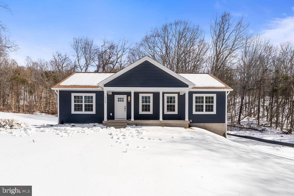 18289 Cameron Road Gordonsville, VA 22942 - Photo 64 of 71 a front view of a house with a yard covered in snow