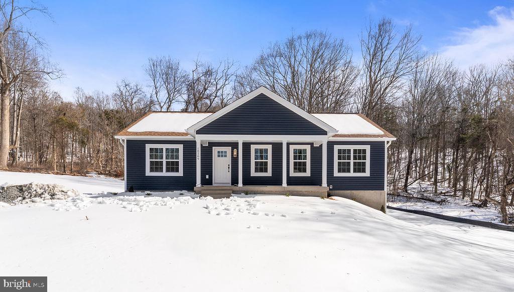 18289 Cameron Road Gordonsville, VA 22942 - Photo 65 of 71 a front view of a house with a yard covered in snow