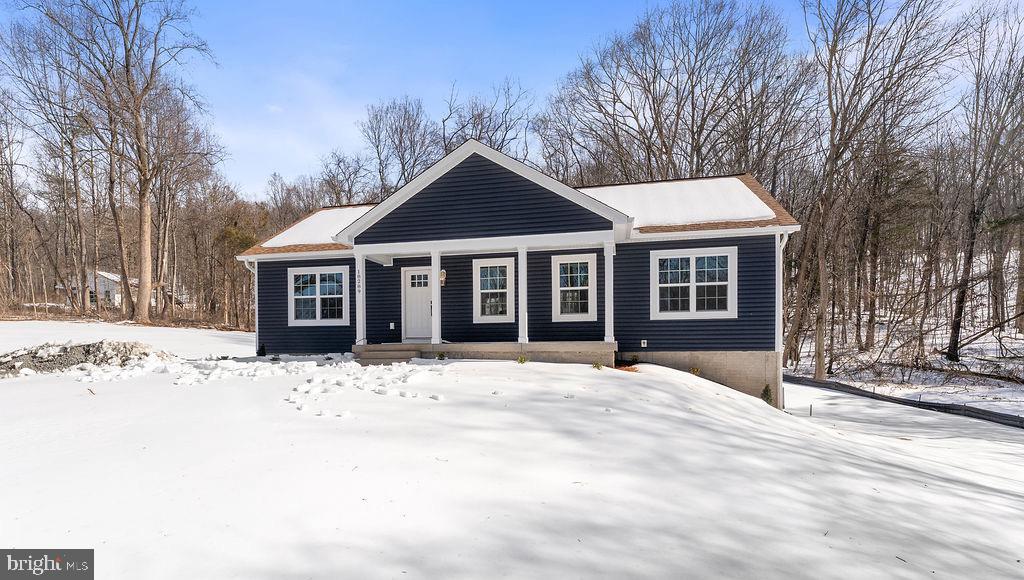 18289 Cameron Road Gordonsville, VA 22942 - Photo 66 of 71 a front view of a house with a yard covered in snow