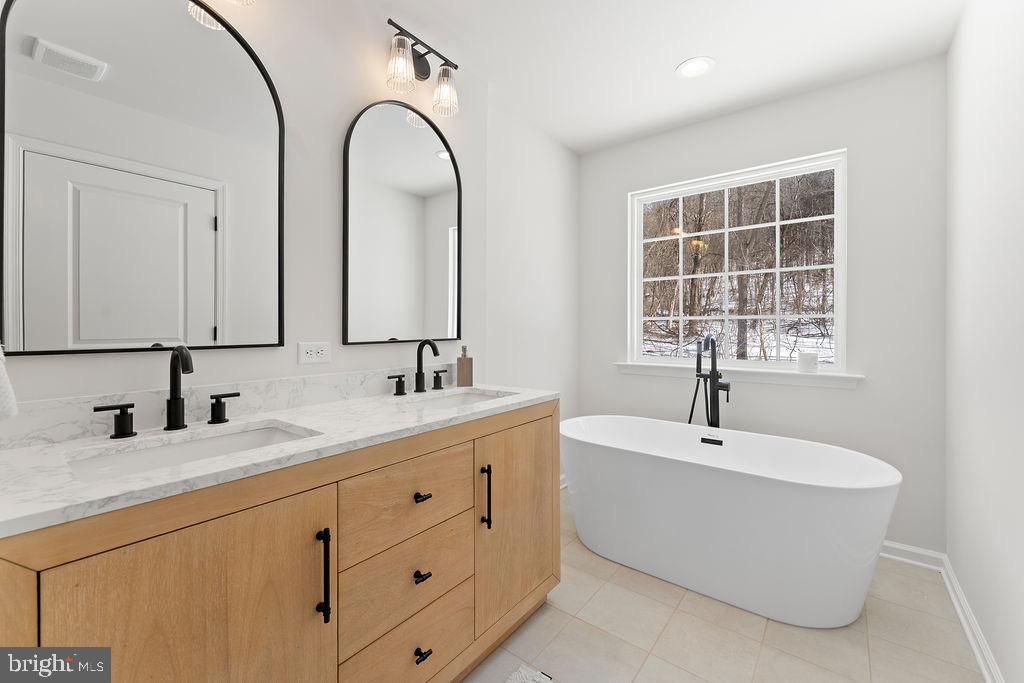 18289 Cameron Road Gordonsville, VA 22942 - Photo 7 of 71 a bathroom with a double vanity sink and mirror