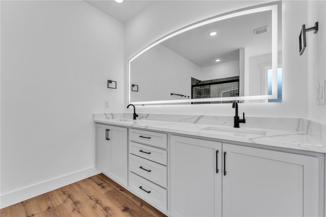 1723 Harris Bridge Road Anderson, SC 29621 - Photo 15 of 33 Modern double vanity with pristine countertops and illuminated mirrors offers a luxurious bathroom experience.