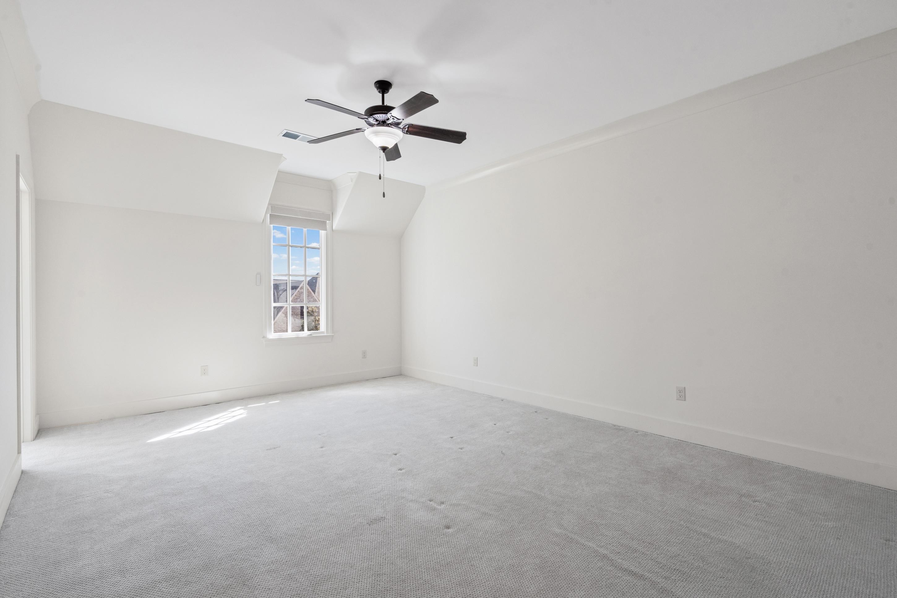 12608 Bravo Road Collierville, TN 38017 - Photo 13 of 40 a view of a room with a ceiling fan and a window