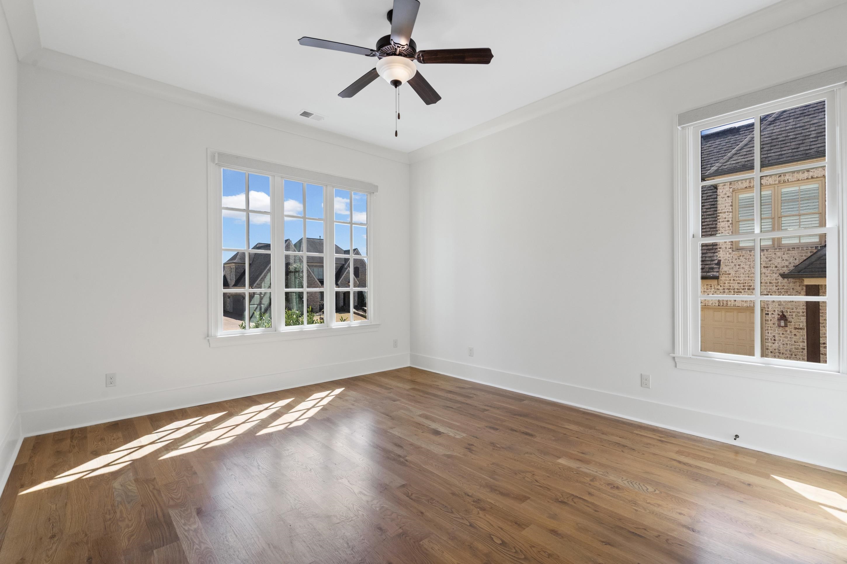 12608 Bravo Road Collierville, TN 38017 - Photo 16 of 40 a view of an empty room with a window and wooden floor