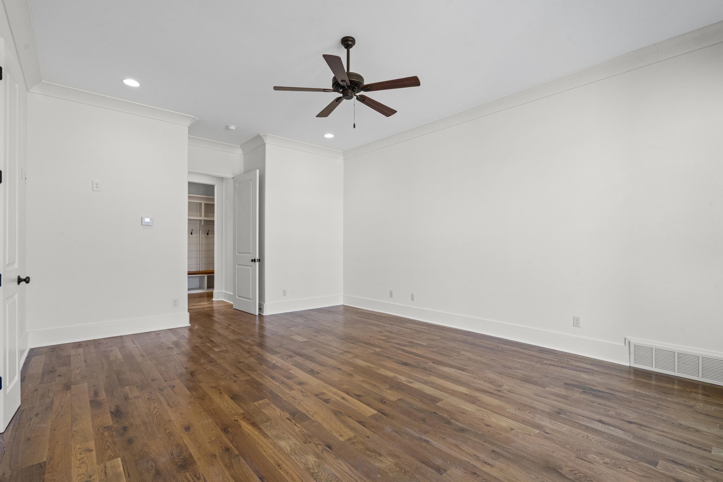 12608 Bravo Road Collierville, TN 38017 - Photo 19 of 40 Spare room featuring recessed lighting, ceiling fan, dark wood-style flooring, and crown molding