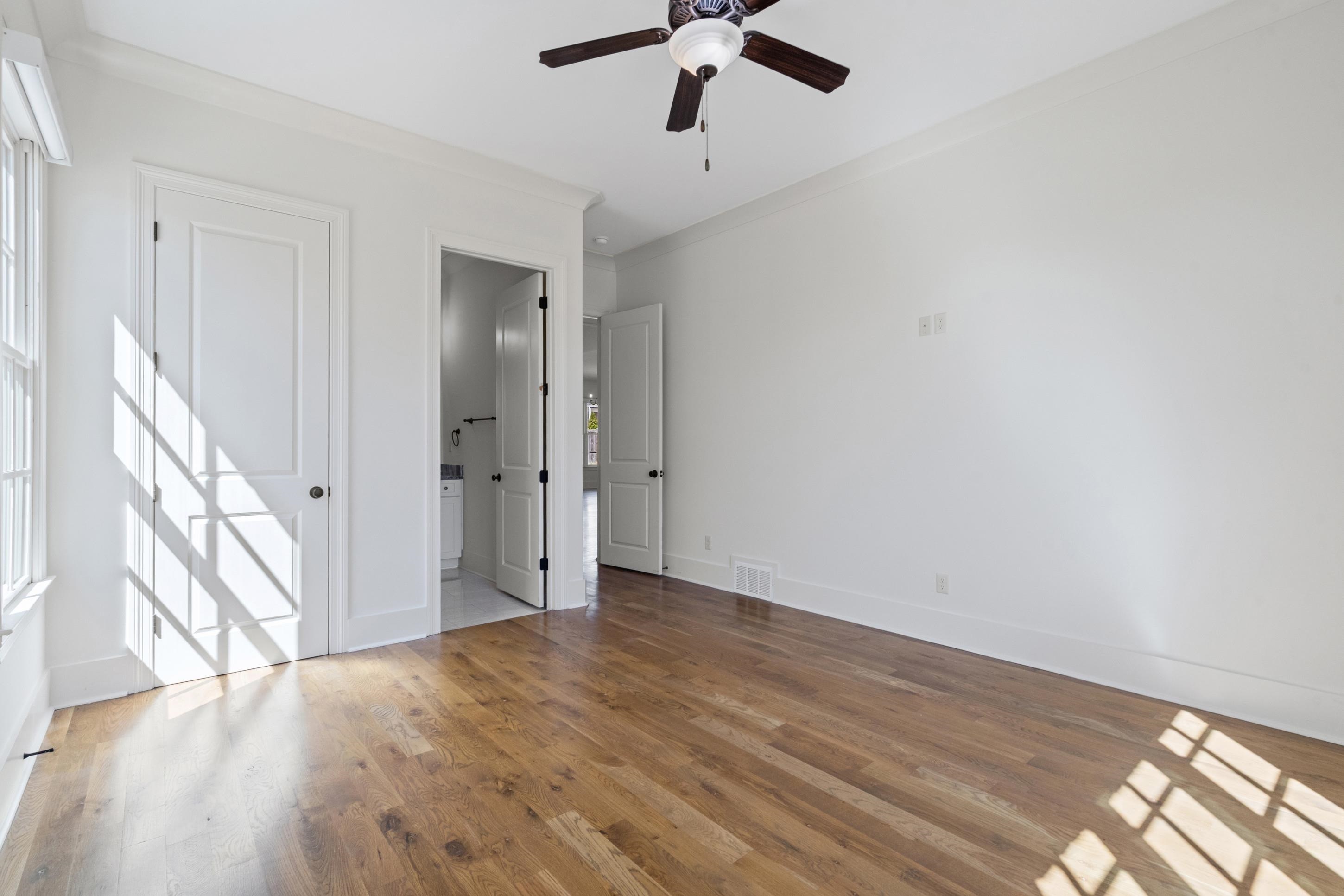 12608 Bravo Road Collierville, TN 38017 - Photo 22 of 40 Unfurnished bedroom featuring connected bathroom, crown molding, light wood-type flooring, and ceiling fan