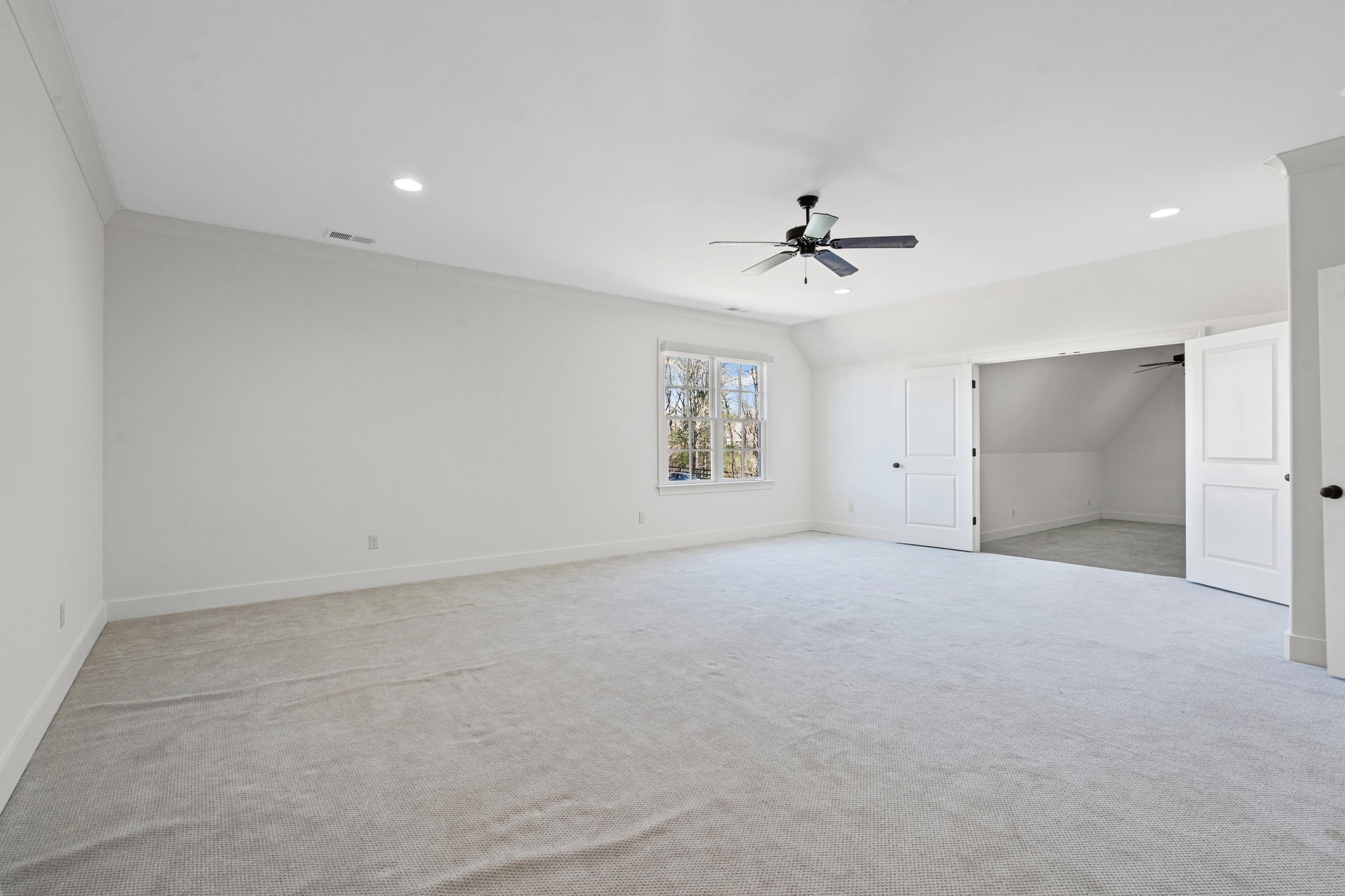 12608 Bravo Road Collierville, TN 38017 - Photo 24 of 40 an empty room with a ceiling fan and a window