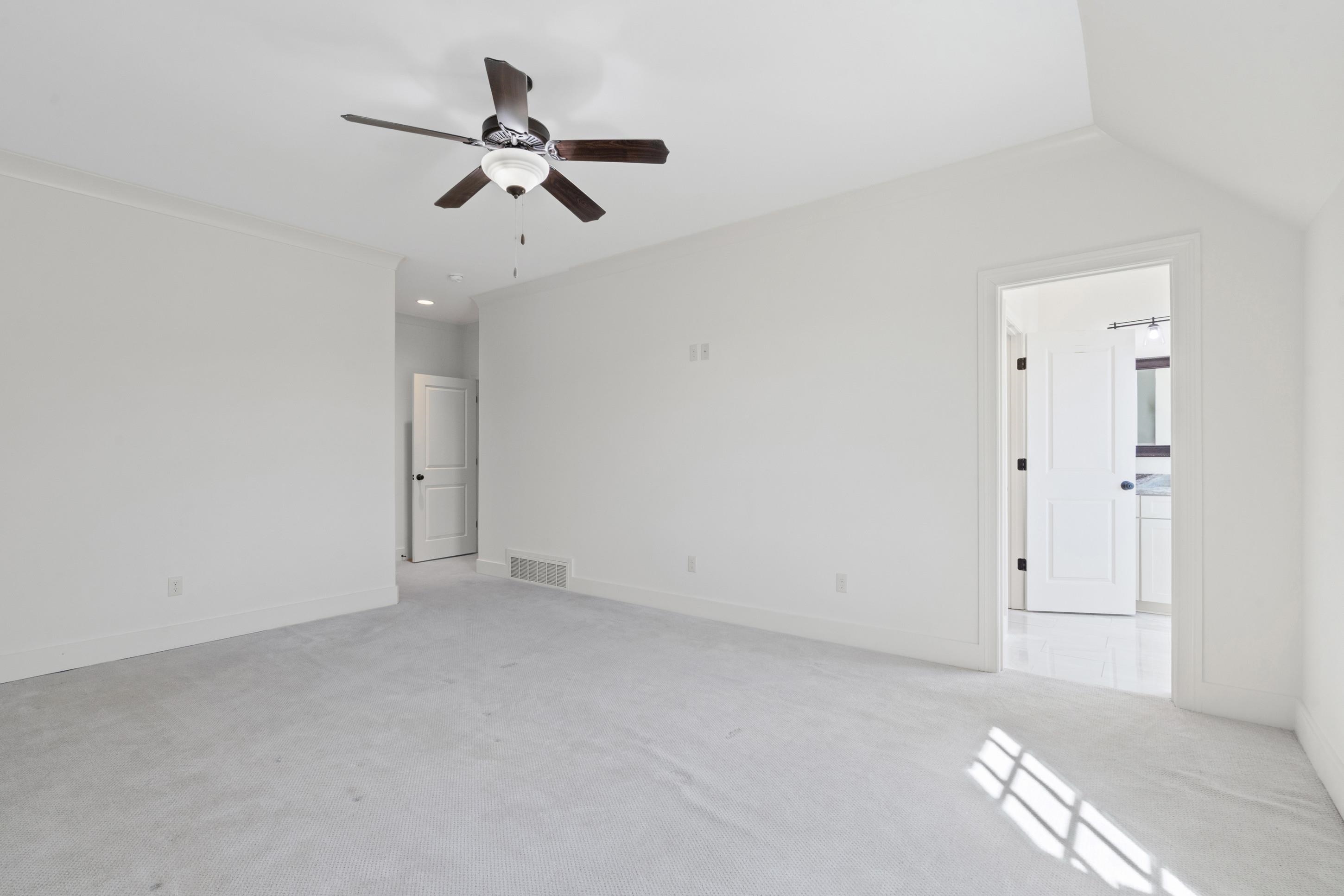 12608 Bravo Road Collierville, TN 38017 - Photo 30 of 40 Spare room with light colored carpet and a ceiling fan