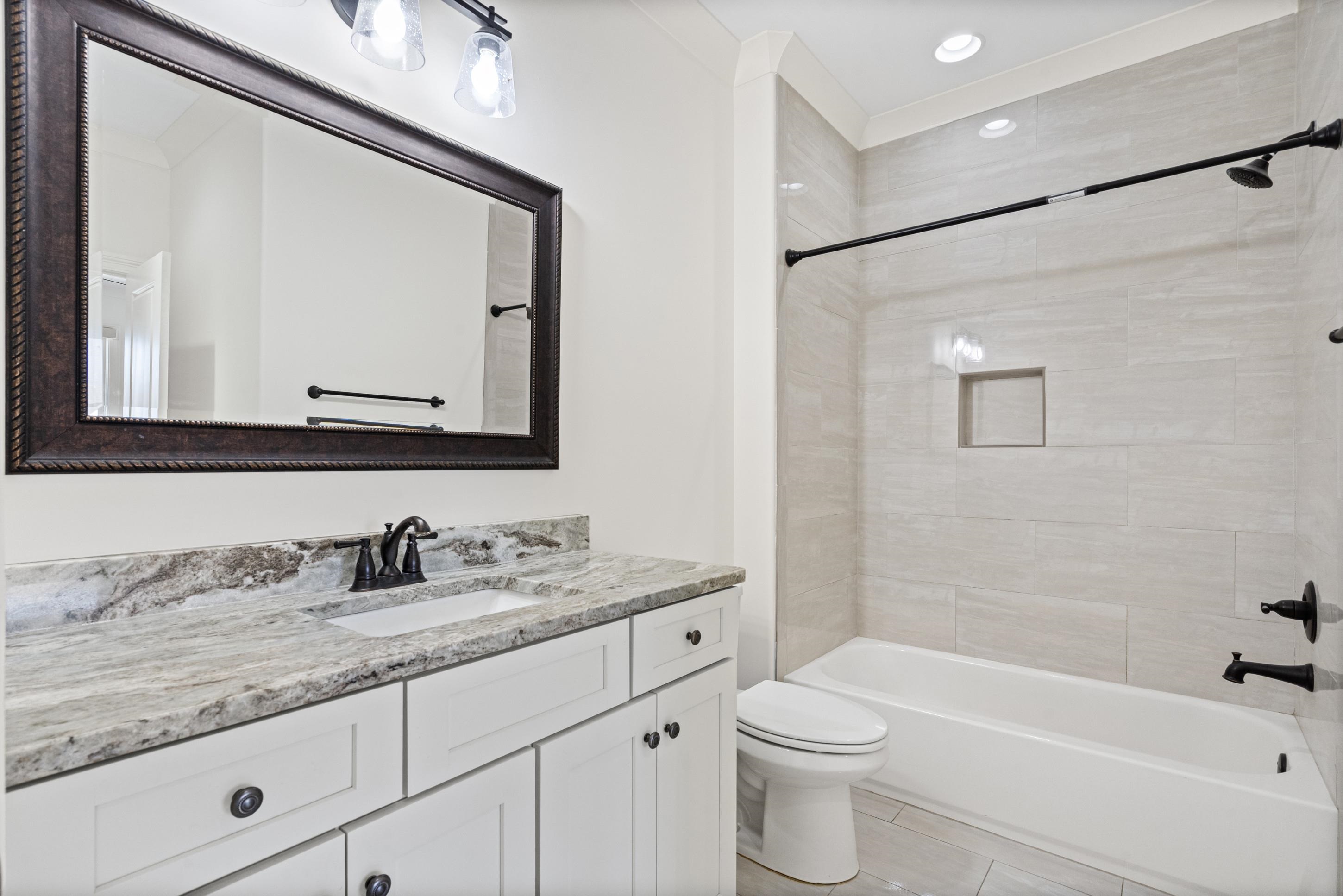 12608 Bravo Road Collierville, TN 38017 - Photo 31 of 40 Full bath with vanity, bathing tub / shower combination, light tile patterned flooring, and recessed lighting