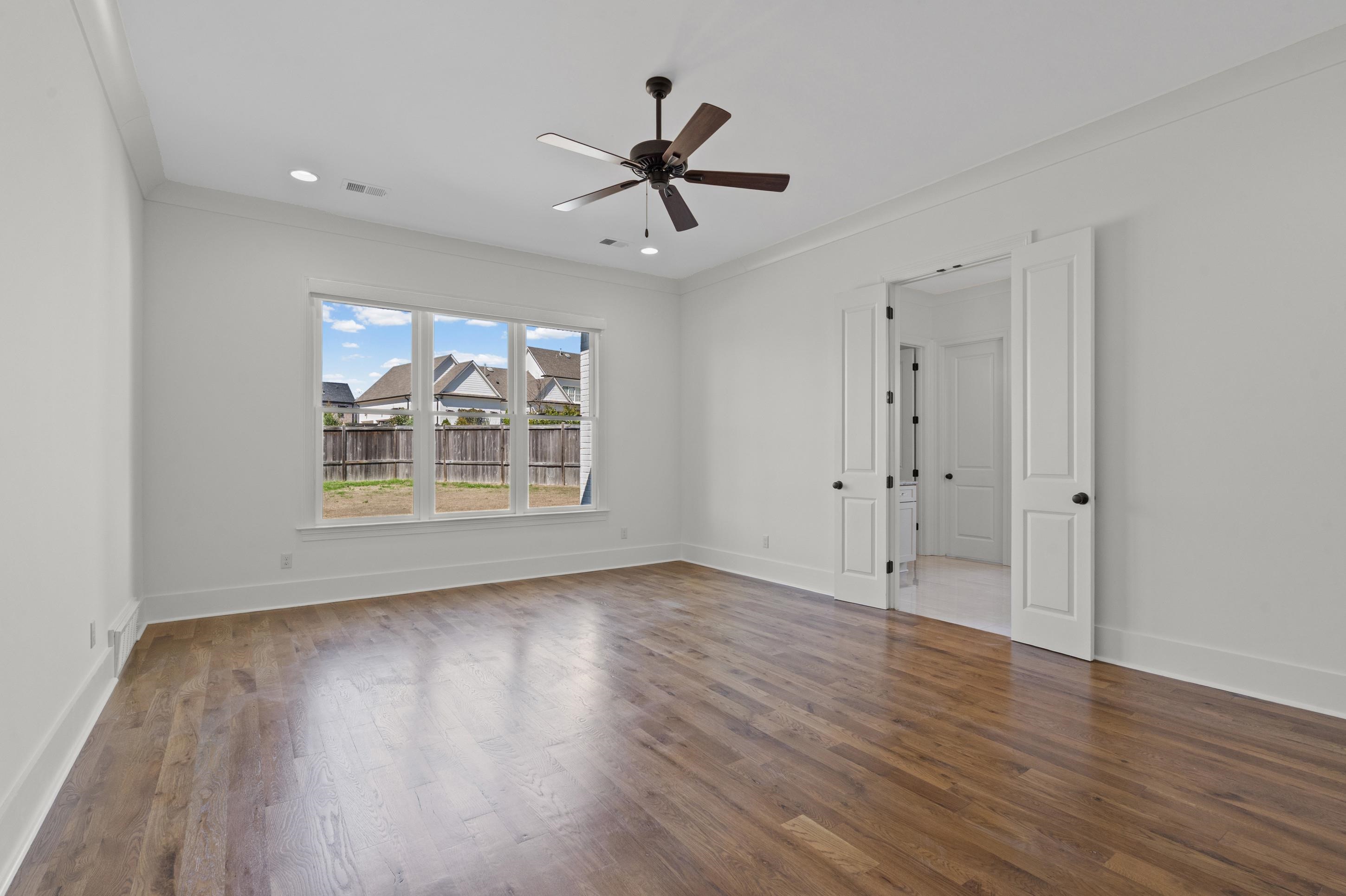 12608 Bravo Road Collierville, TN 38017 - Photo 31 of 40 a view of an empty room with wooden floor and a window