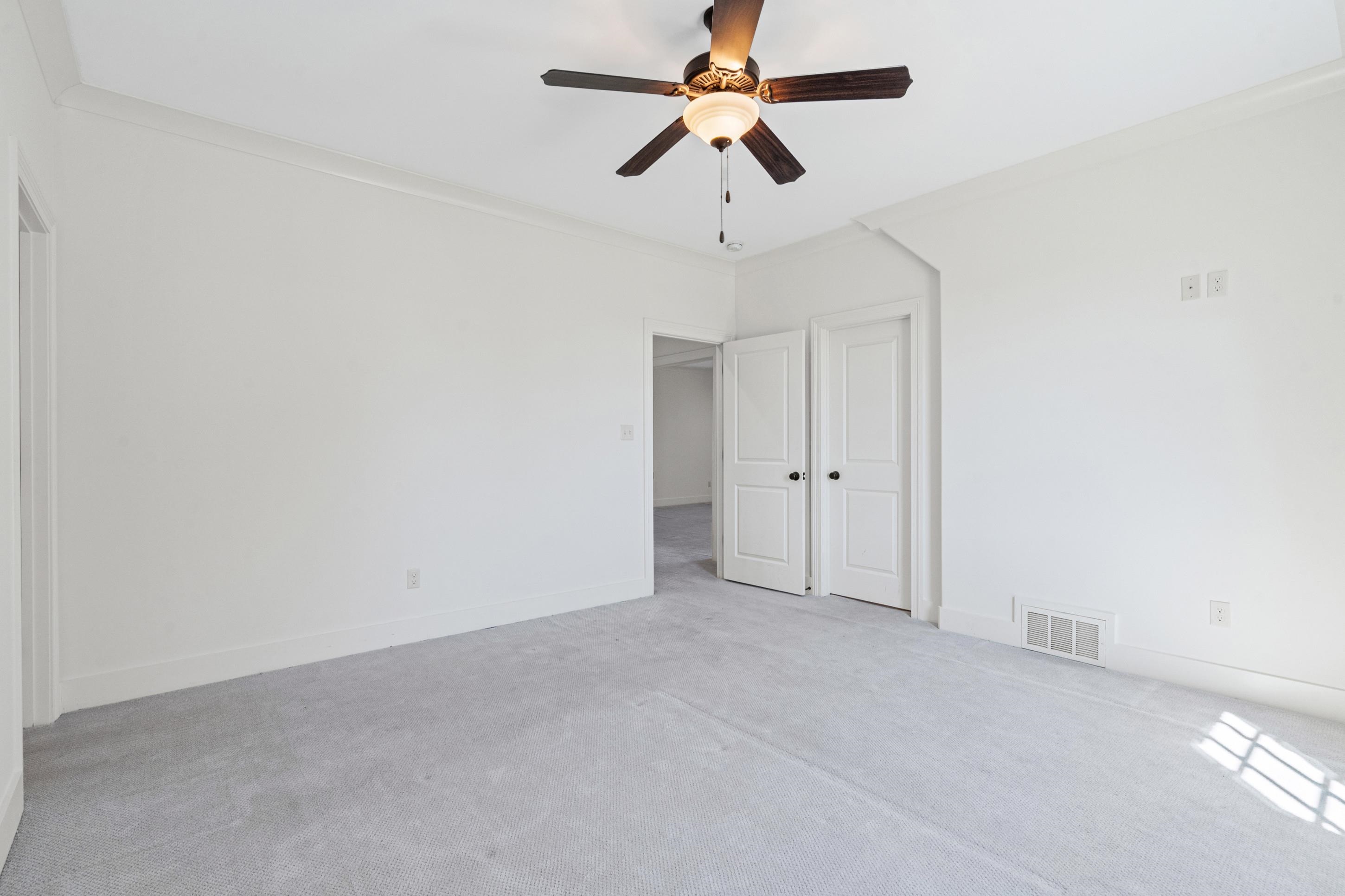 12608 Bravo Road Collierville, TN 38017 - Photo 34 of 40 Unfurnished bedroom with ornamental molding, light colored carpet, and a ceiling fan