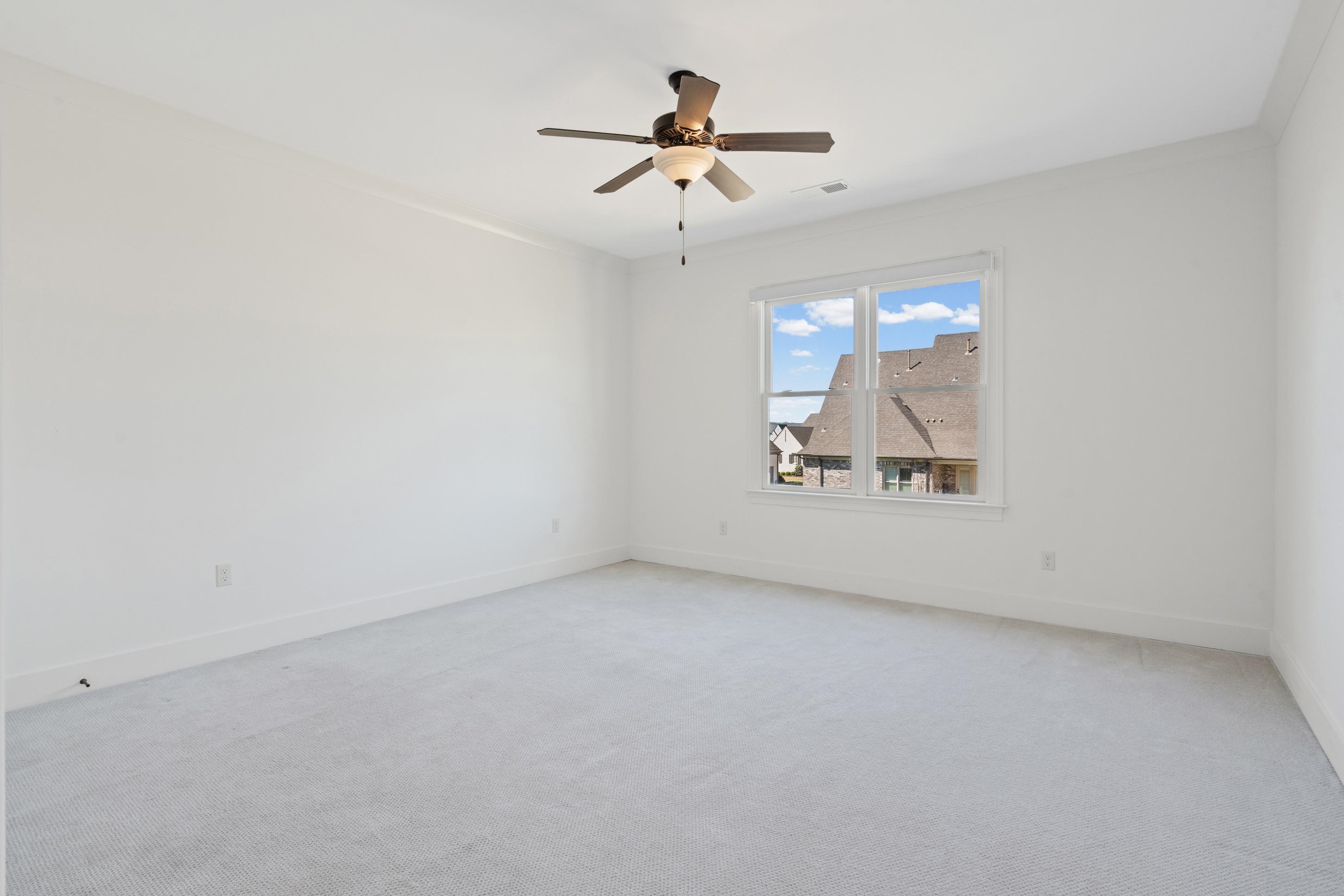 12608 Bravo Road Collierville, TN 38017 - Photo 37 of 40 an empty room with a ceiling fan and window