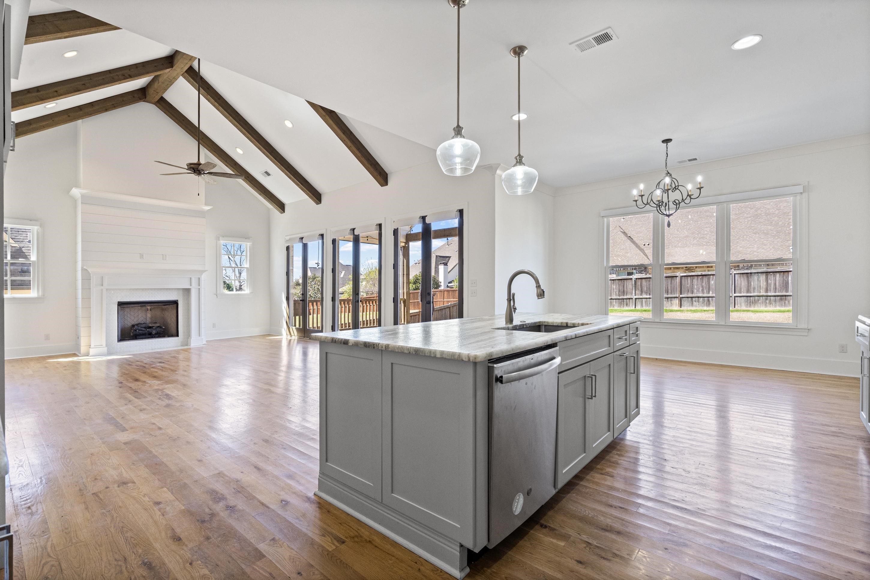 12608 Bravo Road Collierville, TN 38017 - Photo 39 of 40 a kitchen with stainless steel appliances granite countertop a stove a sink and a wooden floor
