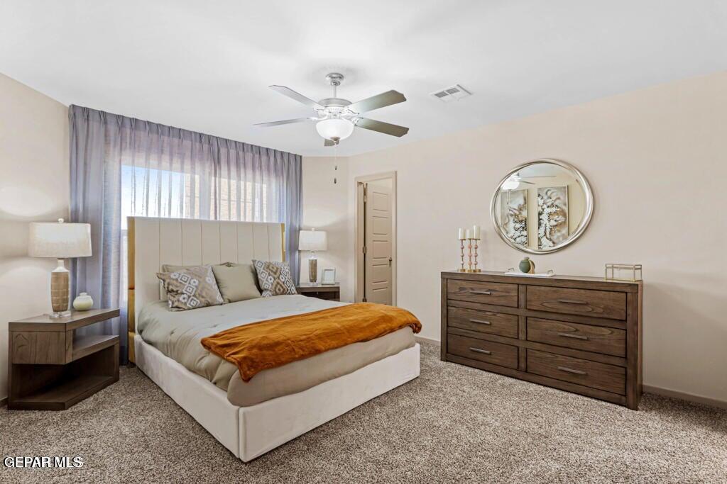 15040 Function Court El Paso, TX 79928 - Photo 5 of 10 a bedroom with a bed and a chandelier