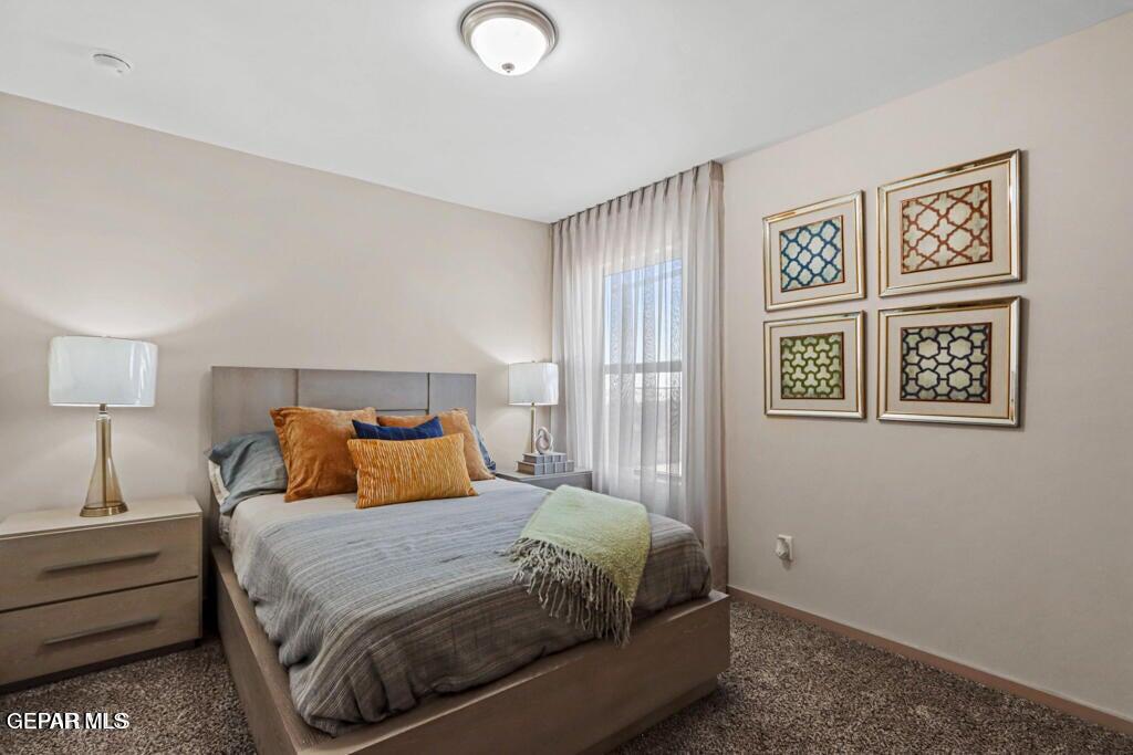 15040 Function Court El Paso, TX 79928 - Photo 8 of 10 a bedroom with a bed and a night stand