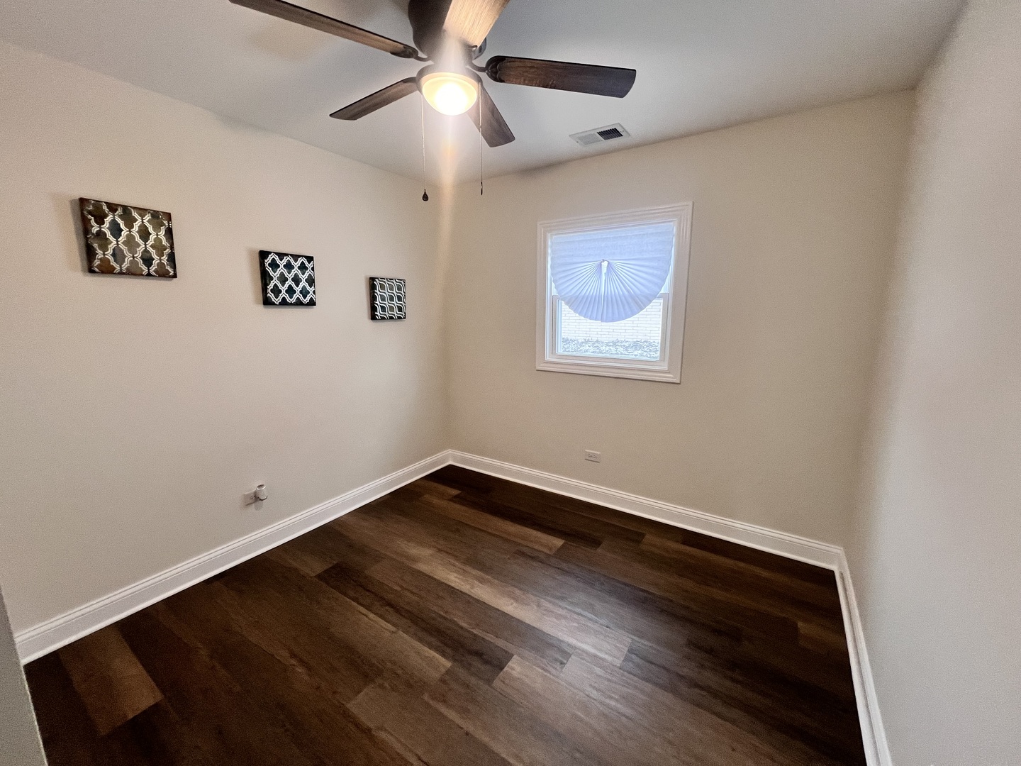 16607 Winchester Avenue Markham, IL 60428 - Photo 16 of 32 a view of room with hardwood floor and a ceiling fan