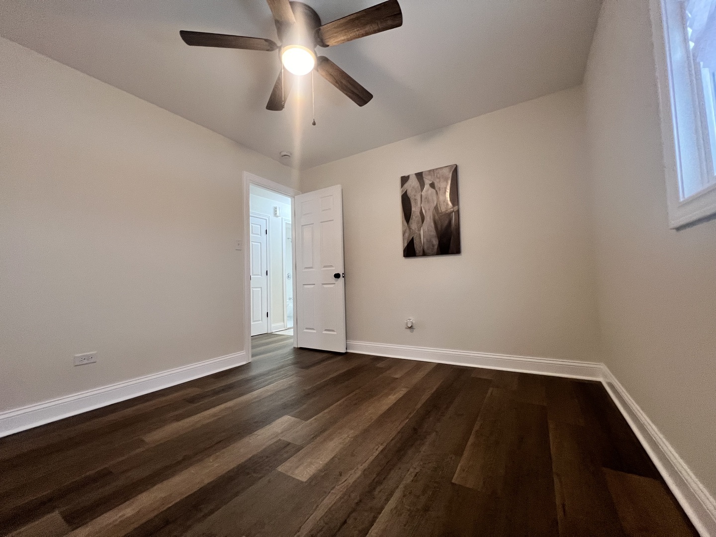 16607 Winchester Avenue Markham, IL 60428 - Photo 19 of 32 an empty room with wooden floor and ceiling fan
