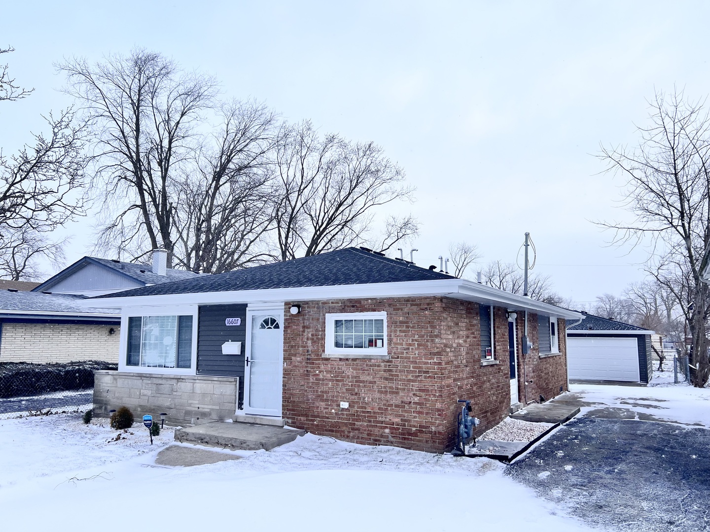 16607 Winchester Avenue Markham, IL 60428 - Photo 2 of 32 a front view of a house with a yard and garage