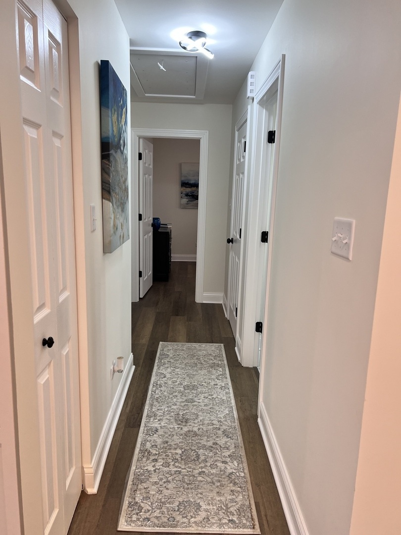 16607 Winchester Avenue Markham, IL 60428 - Photo 10 of 32 a view of a hallway with wooden floor and a bathroom