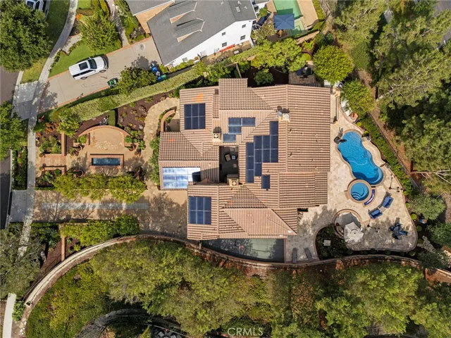 a aerial view of a house with swimming pool garden and patio
