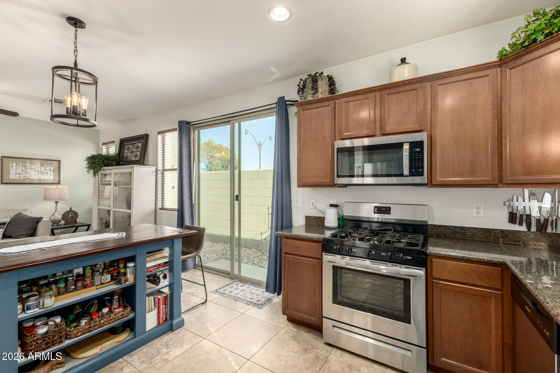 1849 South Balboa Drive Gilbert, AZ 85295 - Photo 12 of 35 a kitchen with stainless steel appliances a stove a sink and a microwave