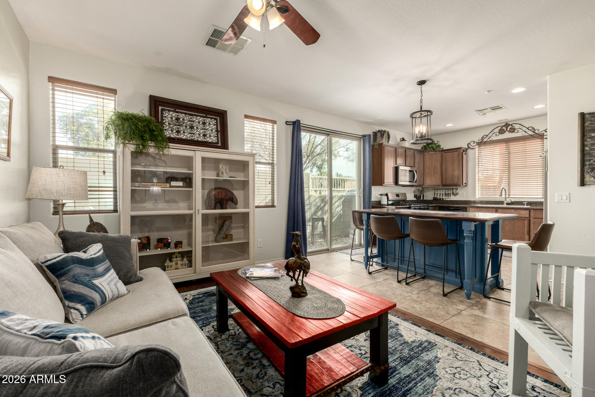 1849 South Balboa Drive Gilbert, AZ 85295 - Photo 14 of 35 a living room with furniture a rug and a chandelier