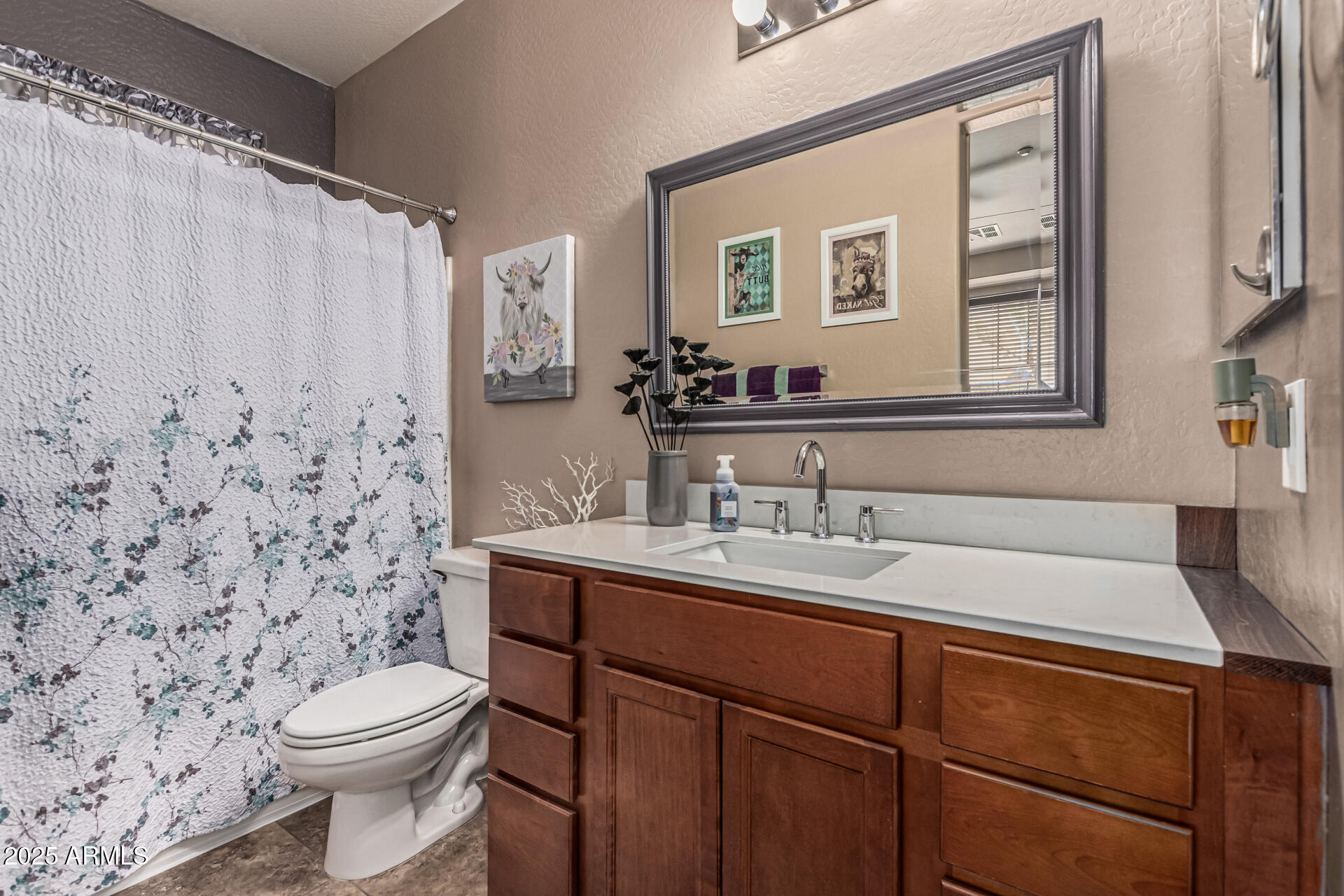 1849 South Balboa Drive Gilbert, AZ 85295 - Photo 25 of 35 a bathroom with a sink a toilet and a mirror