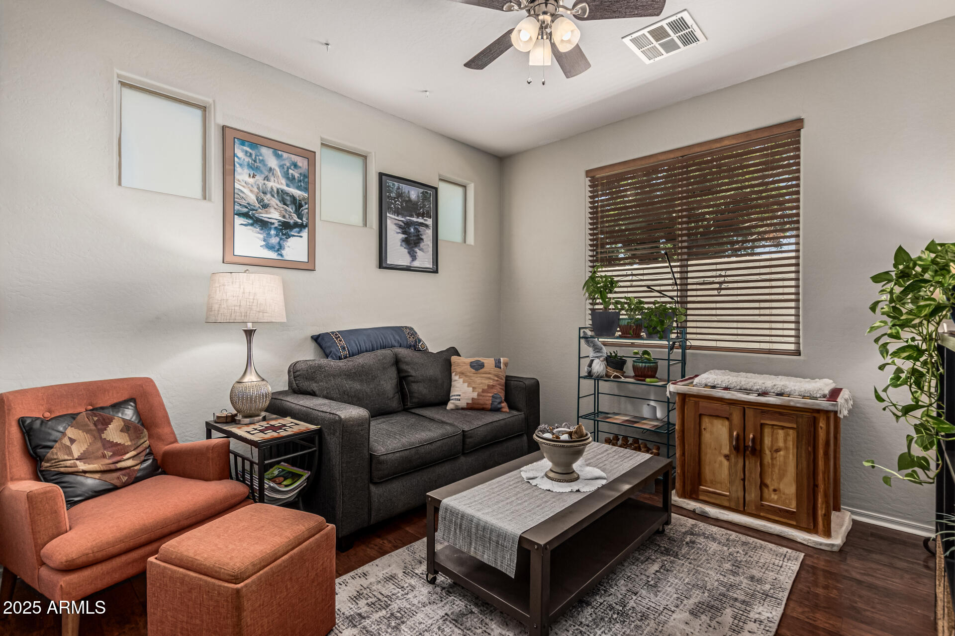 1849 South Balboa Drive Gilbert, AZ 85295 - Photo 26 of 35 a living room with furniture a flat screen tv and a large window