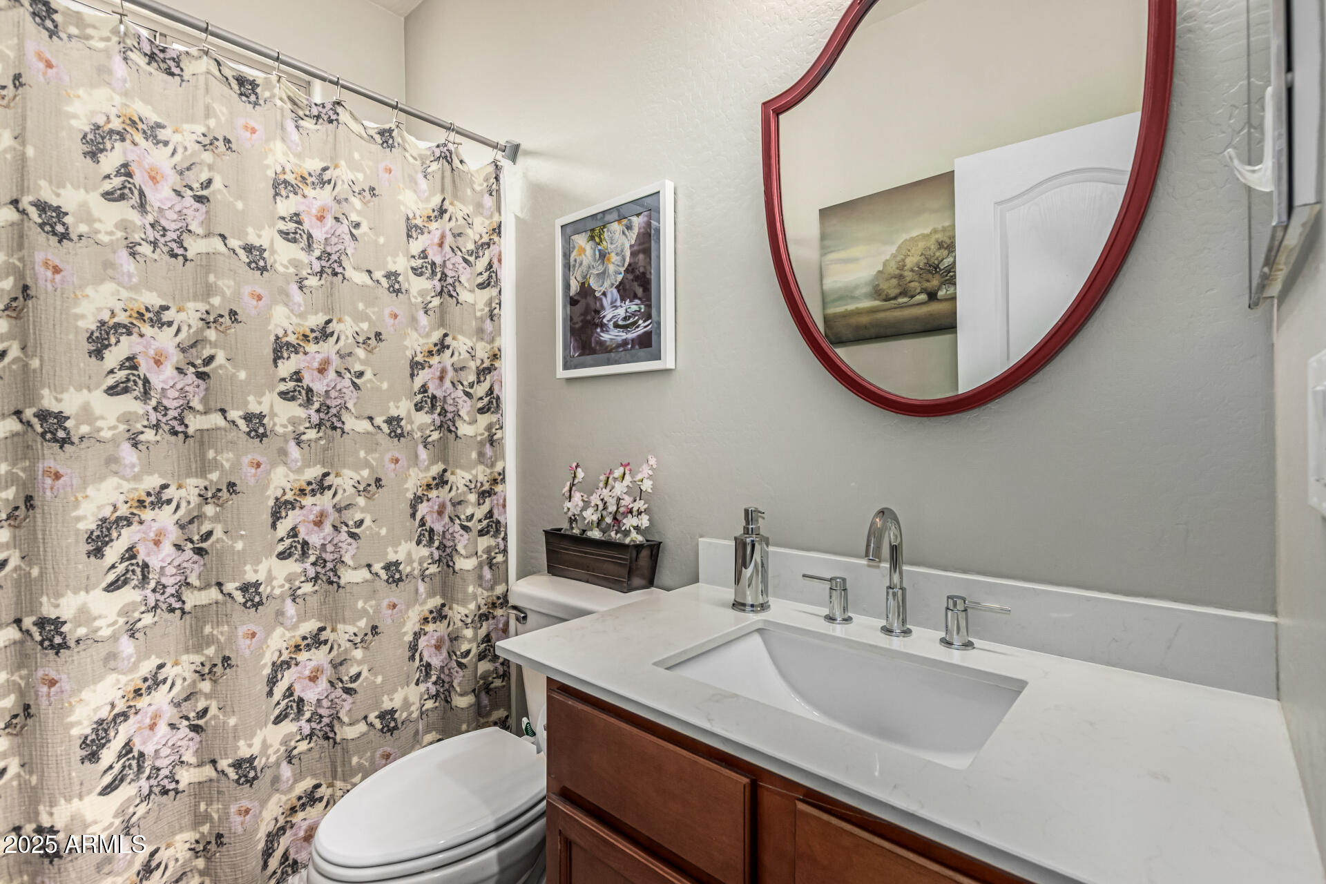 1849 South Balboa Drive Gilbert, AZ 85295 - Photo 28 of 35 a bathroom with a sink a toilet and a mirror