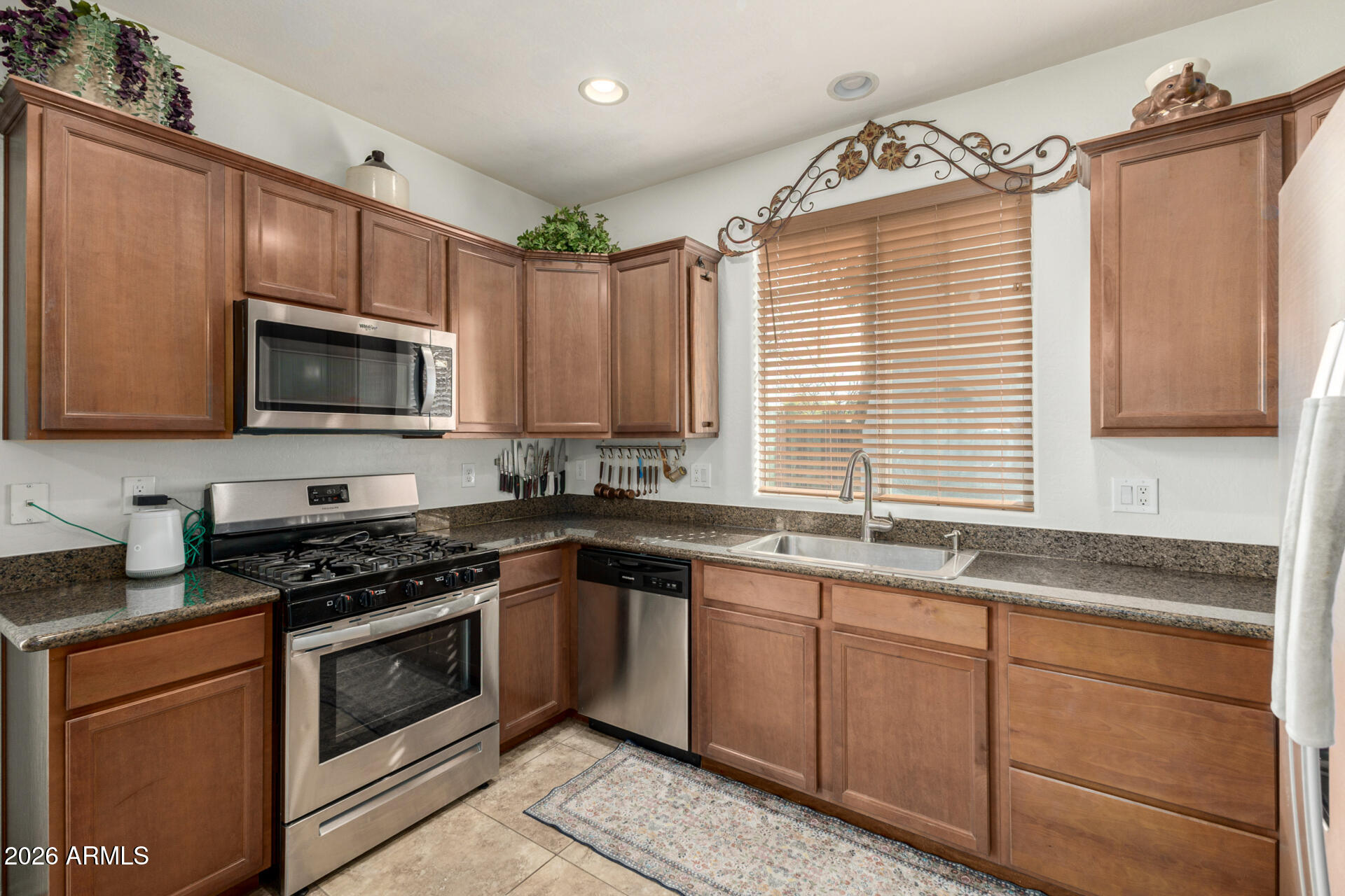 1849 South Balboa Drive Gilbert, AZ 85295 - Photo 8 of 35 a kitchen that has a sink and a stove top oven
