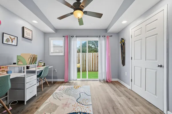 a view of a livingroom with furniture window and wooden floor