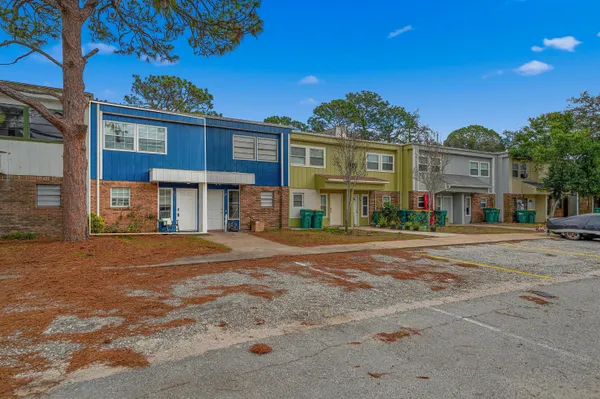 a front view of a residential apartment building with a yard