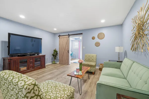 a living room with furniture and a flat screen tv