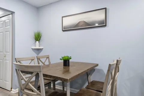 a view of a dining room with furniture and wooden floor