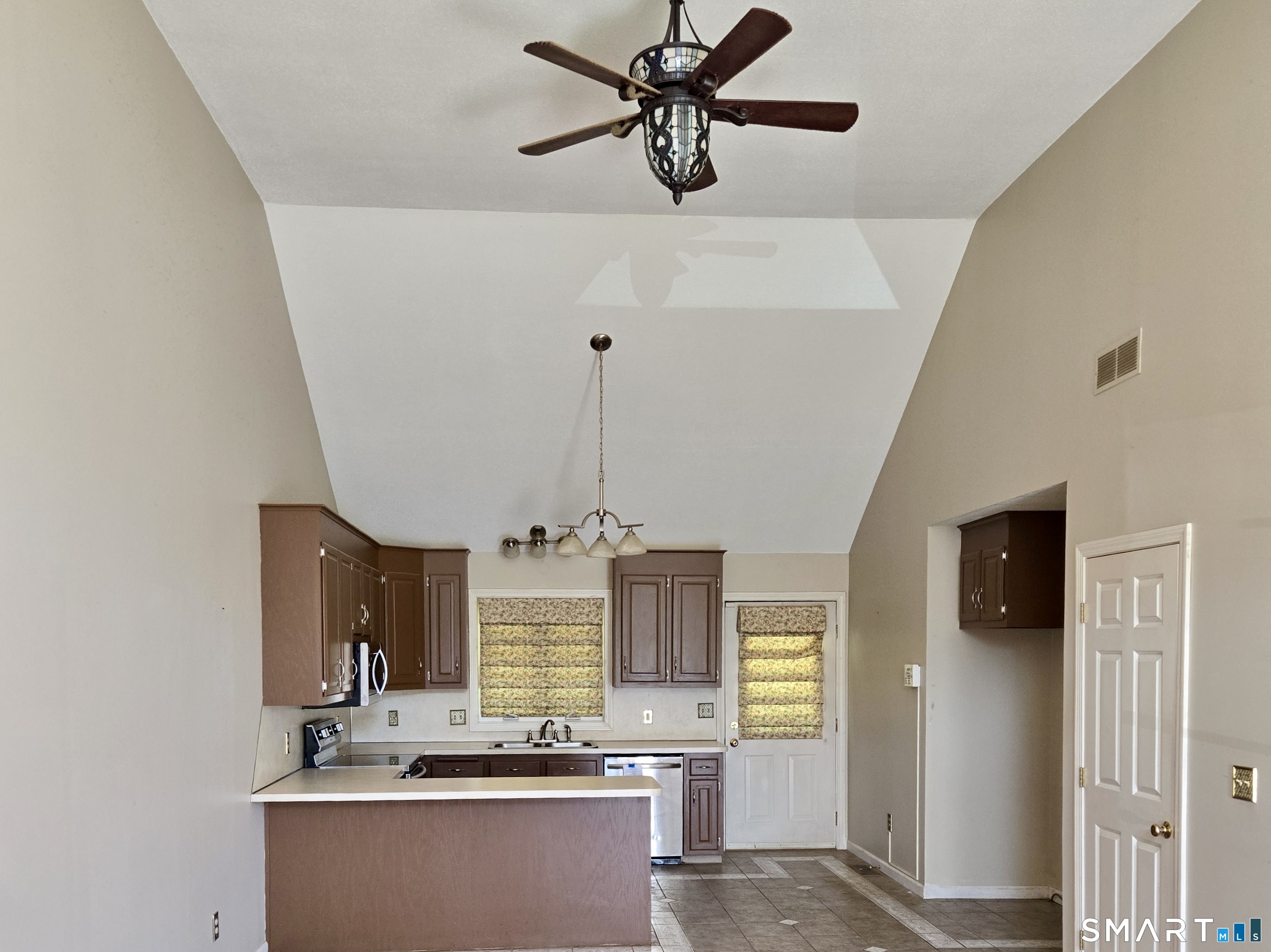 304 Brainard Road, Unit 29 Enfield, CT 06082 - Photo 3 of 10 a view of a kitchen with a sink stainless steel appliances and cabinets