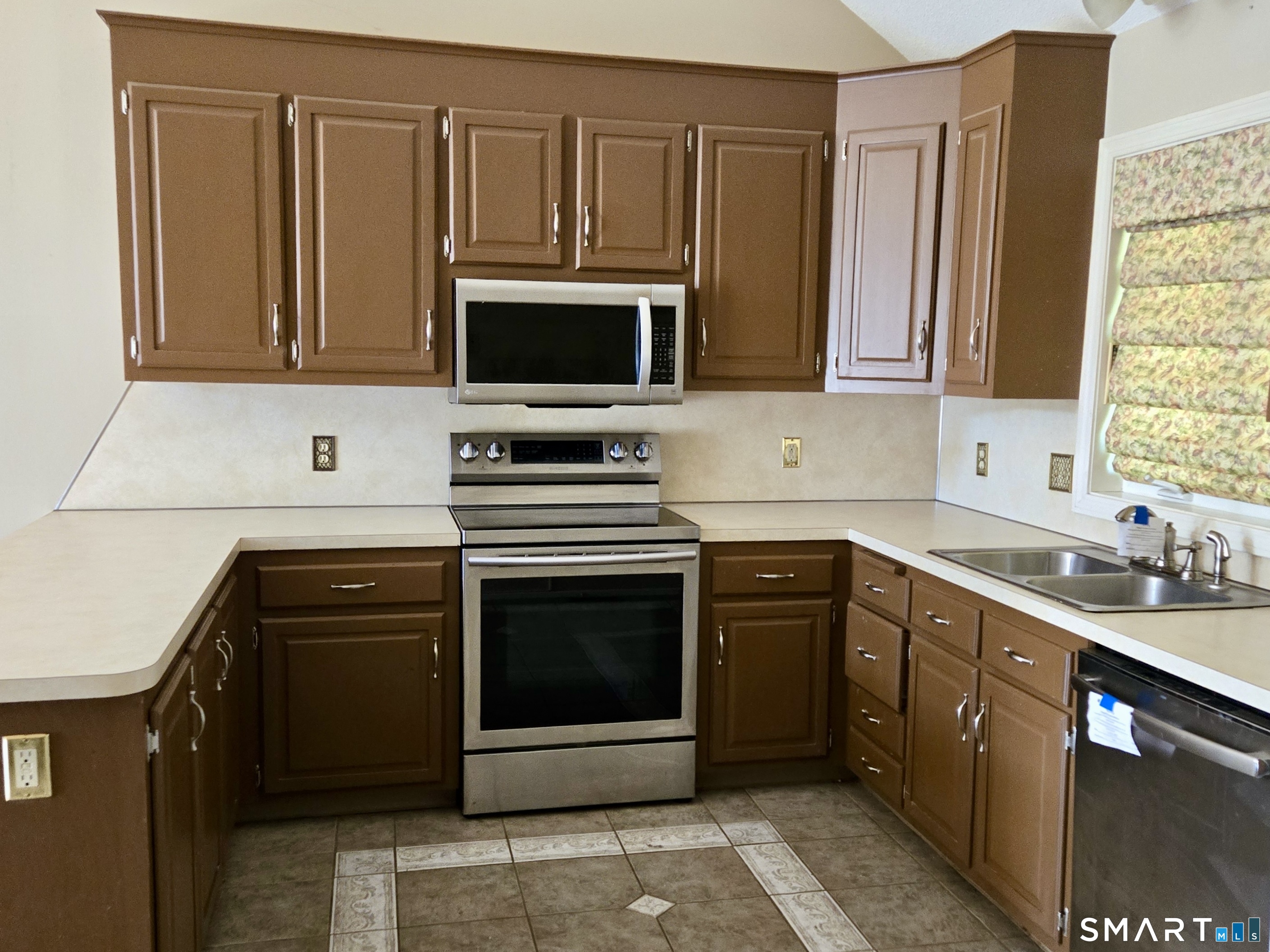 304 Brainard Road, Unit 29 Enfield, CT 06082 - Photo 4 of 10 a kitchen with stainless steel appliances granite countertop a stove microwave and sink