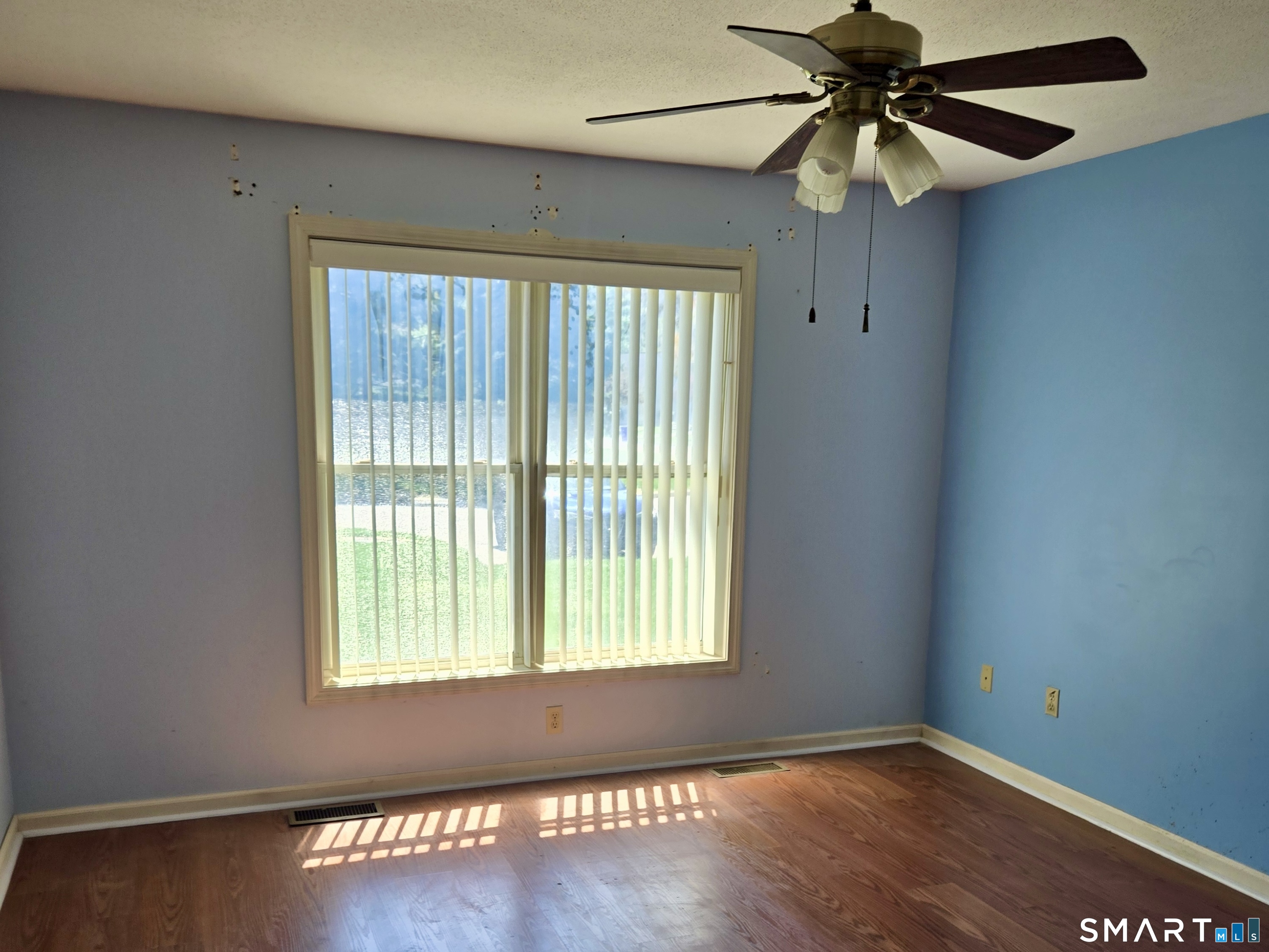 304 Brainard Road, Unit 29 Enfield, CT 06082 - Photo 6 of 10 an empty room with wooden floor fan and windows