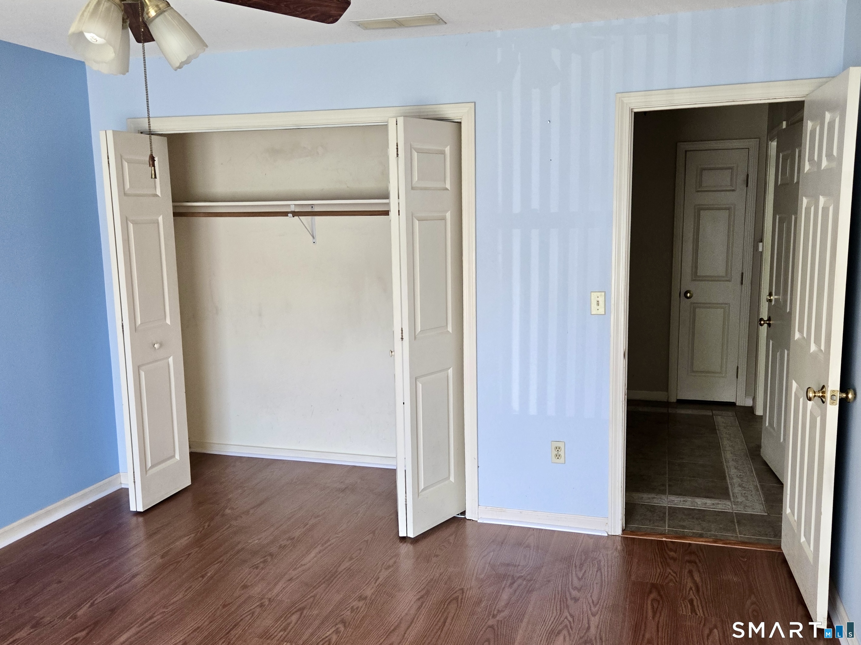 304 Brainard Road, Unit 29 Enfield, CT 06082 - Photo 7 of 10 an empty room with wooden floor and closet