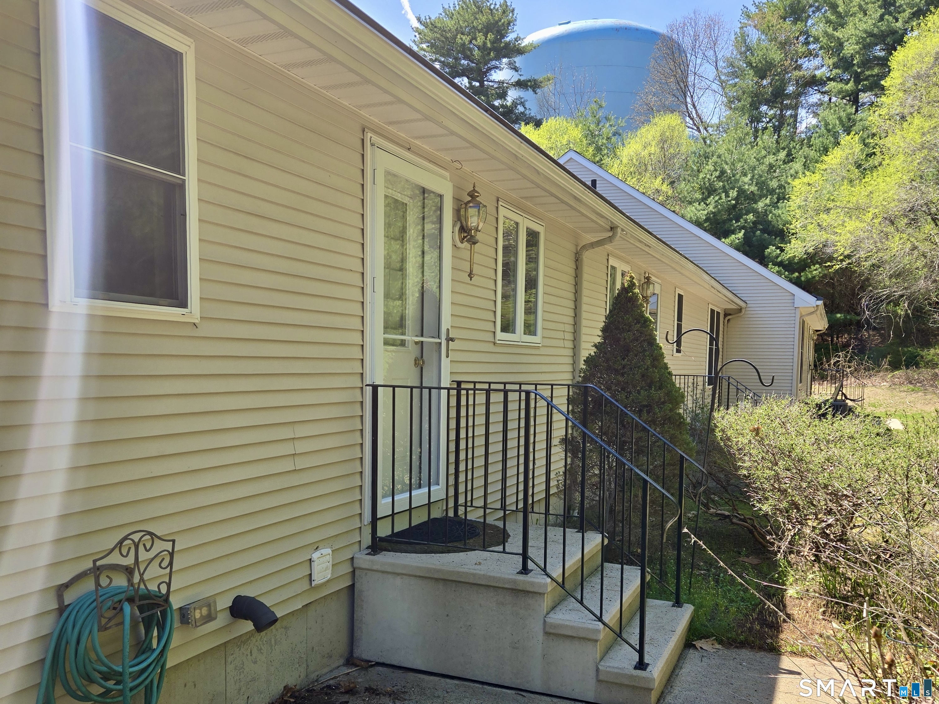 304 Brainard Road, Unit 29 Enfield, CT 06082 - Photo 8 of 10 a view of a house with a small yard and potted plants