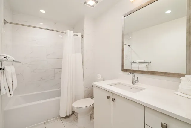 a bedroom with a large bed and a large window