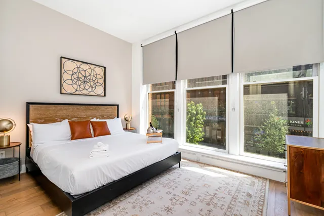 a bedroom with a large bed and a large window