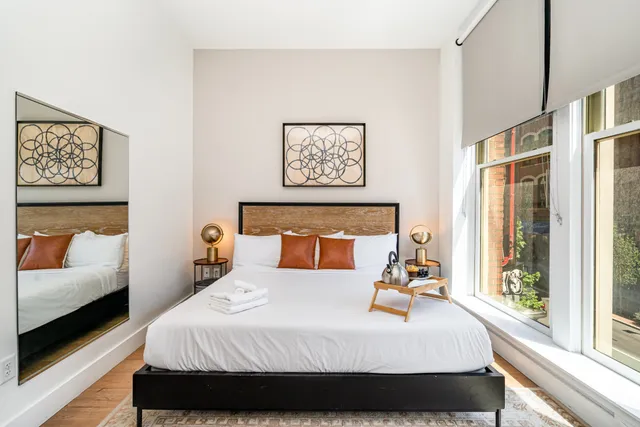 a view of a livingroom with furniture a fireplace a swimming pool and outdoor space