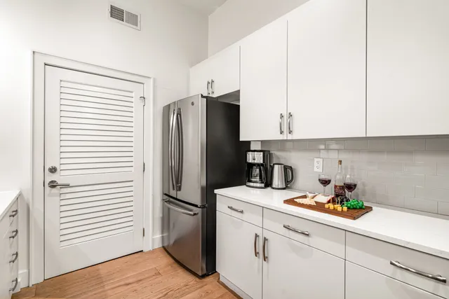 a kitchen with a refrigerator and cabinets